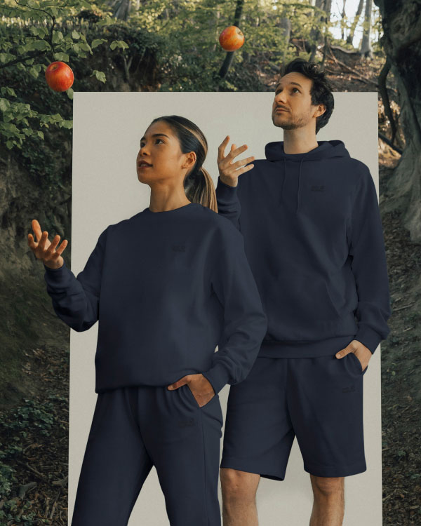 Man and woman throwing an apple into the air