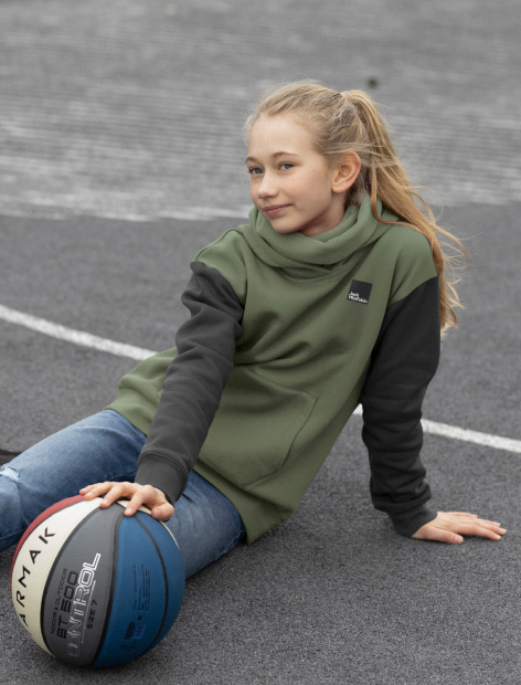 Girl sitting on the ground with a basketball